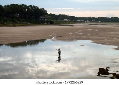 Wells, ME, USA - July 23, 2020: Fly fishing in the lagoon at the Ogunquit River estuary, view at sunset