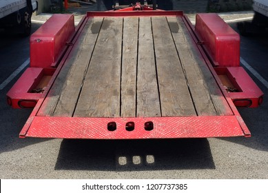 Well-used Empty Red Flatbed Trailer