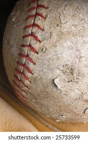 Well-used Softball With Red Stitching In Mitt