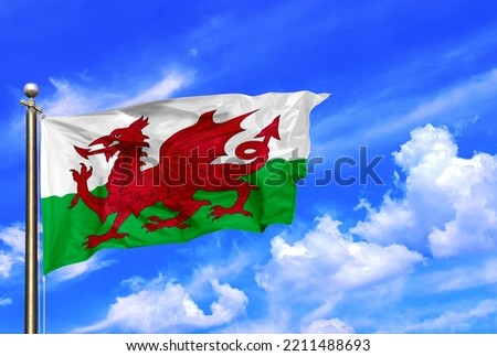 Welsh Flag Waving In The Wind On A Beautiful Summer Blue Sky