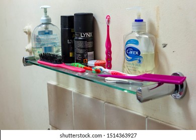 WELWYN GARDEN CITY, UK - SEPTEMBER 23, 2019: Messy Bathroom Shelf With Tooth Brushes And Soap