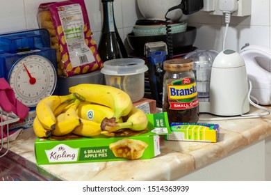 WELWYN GARDEN CITY, UK - SEPTEMBER 23, 2019: Various Food Items And Pain Killers On A Messy Kitchen Worktop