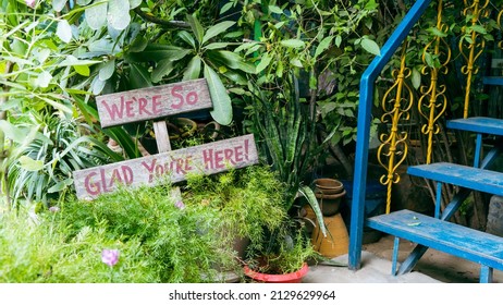 We're So Glad You're Here Sign At Guesthouse