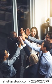 Were going to succeed no matter what. Shot of a group of businesspeople high fiving in an office.
