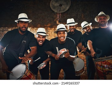 Were here to entertain you tonight. Portrait of a group of musical performers playing drums together.