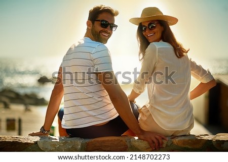 Were not ready to go home yet. Shot of a happy young couple enjoying a summers day outdoors.