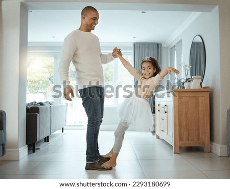 Were practicing for our first daddy and daughter ball. a little girl wearing her tutu and tiara while dancing with her father at home.