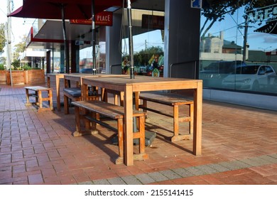 Werribee, Vic Australia - May 8 2022: Outdoor Cafe Dining Chairs And Tables On Pavement In Morning Sunlight