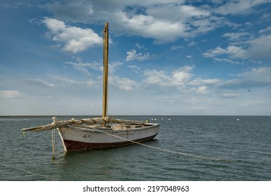 West Africa. Mauritania. A Fishing Boat Under Sail Floats In The Waters Of The Atlantic Ocean Along The Shore Of The Bank National Nature Park. This Is The Main Water Transport Of Local Fishermen.