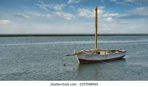 West Africa. Mauritania. A Fishing Boat Under Sail Floats In The Waters Of The Atlantic Ocean Along The Shore Of The Bank National Nature Park. This Is The Main Water Transport Of Local Fishermen.