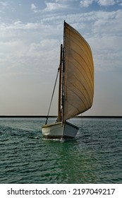 West Africa. Mauritania. A Fishing Boat Under Sail Floats In The Waters Of The Atlantic Ocean Along The Shore Of The Bank National Nature Park. This Is The Main Water Transport Of Local Fishermen.