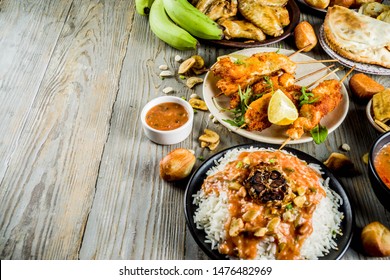 West African Food Concept. Traditional Wset African Dishes Assortment - Peanut Soup, Jollof Rice, Grilled Chicken Wings, Dry Fried Bananas Plantains, Nigerian Chicken Kebabs, Meat Pies, Top View