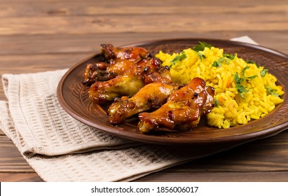 West African Food. Rice With Fried Chicken, Herbs And Spices, On A Plate