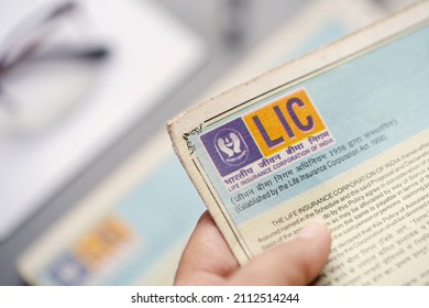 West Bengal, India, January 28, 2021 : A Man Or LIC Policy Holder Looking At His Life Insurance Papers And Premium. Concept For LIC IPO, Privatization Of Government Companies.