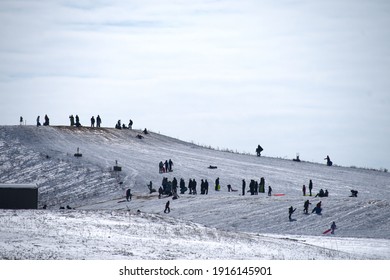 West Chester Township, Ohio, USA, February , 2021:  Sledding On A Hill At The Voice Of America Park.