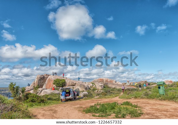 WEST COAST NATIONAL\
PARK, SOUTH AFRICA, AUGUST 20, 2018: Tourists at the Perlemoen\
Lookout Point at Postberg near Langebaan on the Atlantic Ocean\
coast. A vehicle is\
visible