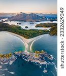 The West Coast of Vancouver Island, British Columbia, Canada near Tofino. Beautiful sand beach, turquoise ocean, green rainforest and mountians. Sunset in Pacific North West. Portrait layout.