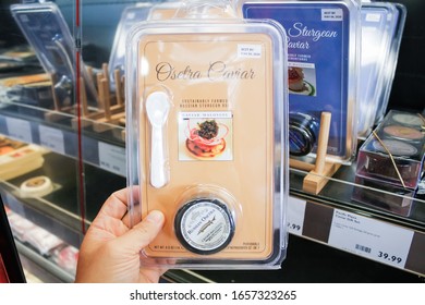 West Covina, California, United States - 02-19-2020: A Hand Holds A Package Of Osetra Caviar On Display At A Local Grocery Store.