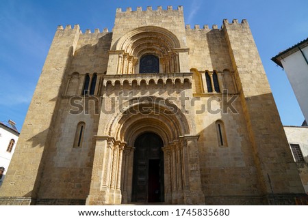  west facade of old romanesque cathedral in Coimbra                              