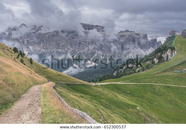 West  face of Sella mountain Group as seen on a\
cloudy day from high route trail from Ciampinoi cable car station\
(above Selva village) to Sella Pass, above Val Gardena, Dolomites,\
South Tyrol, Italy