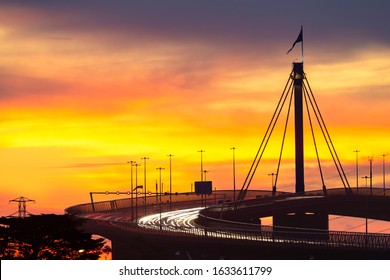 West Gate Bridge Multi-lane Highway In Melbourne City During Rush Hour With Traffic Congestion And Light Trails From Traffic Headlights At Sunset.