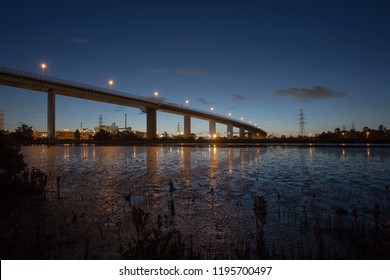 The West Gate Bridge On Its Way Into Melbourne From The Western Suburbs. Low Tide Over Stoney Creeks Mangrove Mud Flats. The Retreating Tide Reveals Thousands Of Mirror Like Reflection Pools.