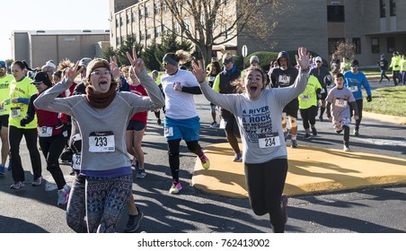 West Islip, NY, USA - 24 November 2017: Young Girls Wave To The Camera And Stick Out Their Tongue During The Excitment Of The Start Of The Run Your Turker Off 4K Race.