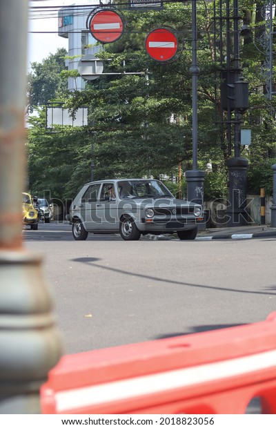 West Java, Indonesia - May 26, 2021 : Classic gray\
Volkswagen Golf car driving on the road in Bandung, West Java on\
May 26, 2021