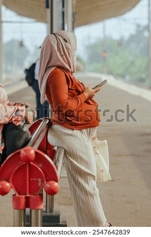 West Java, Indonesia on November 15 2024. Pregnant woman waiting for train. 