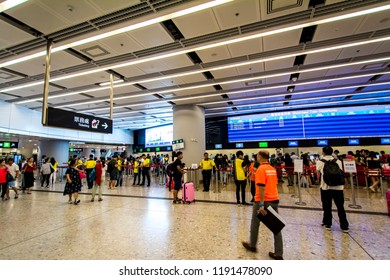 WEST KOWLOON, HONG KONG - SEP 29, 2018: Passenger Queuing At The Ticket Office With A Screen Showing Rail Timetable  At The West Kowloon High Speed Rail Station For High Speed Rail Tickets To China