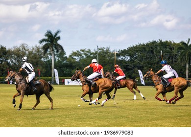WEST PALM BEACH, FL - MARCH 14, 2021: Coca Cola plays the ball against Pilot polo team during the USPA Gold Cup on March 14, 2021 at the International Polo Club in West Palm Beach, Florida.