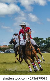WEST PALM BEACH, FL - MARCH 14, 2021: Coca Cola plays the ball against Pilot polo team during the USPA Gold Cup on March 14, 2021 at the International Polo Club in West Palm Beach, Florida.