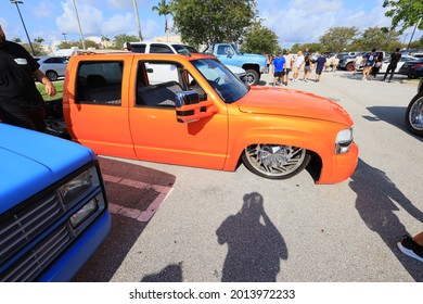 West Palm Beach, Florida US - July 25 2021 Cars And Coffee Palm Beach Outlets. Orange Low Rider Truck 