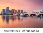 West Palm Beach, Florida, USA. Cityscape image of West Palm Beach, Florida with reflection of the city skyline in the water at beautiful sunset.