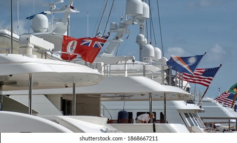 WEST PALM BEACH, FLORIDA, USA - CIRCA JANUARY 2020: Country Of Registration Flags On Yachts In The Harbor