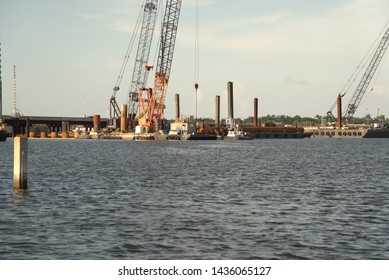 West Palm Beach, Florida/U.S.A-June 27 2019: Construction Of A New Bridge Using Cranes And Barges To Lay The Concrete Foundation On The Sea Bed. 