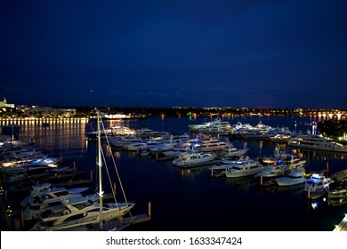 West Palm Beach, FL/USA - 12/14/19: Nightime Picture Of Palm Harbor Marina. Yachts, Palm Beach A The Breakers In The Background.