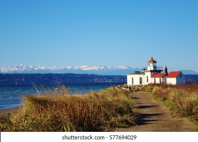 West Point Light is a lighthouse at Discovery Park in Seattle on Puget Sound's Elliott Bay. A hiking path leads to the lighthouse & beautiful view of snow capped Olympic Mountains on clear winter day.
