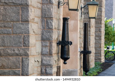 West Point, New York - August 30, 2019: Cannon Barrels Are Seen Mounted To The Stone Wall Near The Door Of An Historic Building On The Campus Of The West Point Military Academy