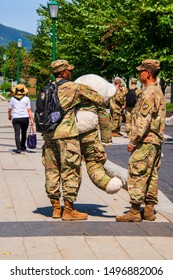 West Point, New York - August 30, 2019: Two West Point Military Academy Cadets Talking On Campus. One Is Holding A Stuffed Bear In Uniform Unit Mascot.