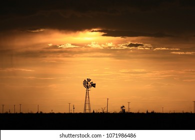 West Texas Sunset. Windmill And Pump Jack.