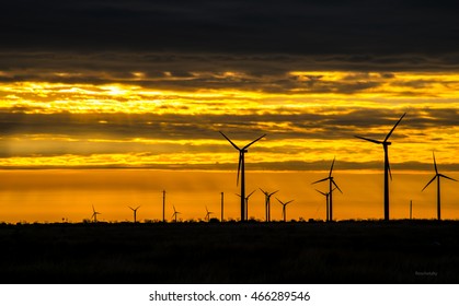 West Texas Wind Turbine Farm At Sunrise Producing Clean Renewable Energy Day And Night Turbines On The Right Side Of Shot 