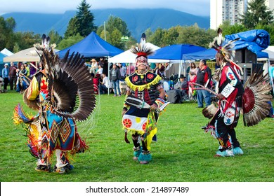 WEST VANCOUVER, BC, CANADA - AUGUST 30 : Three Unidentified First Nation men take part in Grand Entry of the Squamish Nation 27th Annual Pow Wow in West Vancouver, Canada on August 30 2014