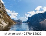 Western Brook Pond, a fjord formed by glacial erosion. Blue sky, summer, the steep mountains on both sides of the canyon. -Gros Morne National Park of Canada, NL, Canada. 