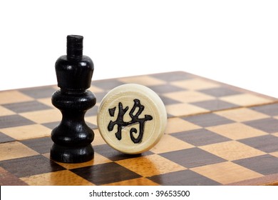 Western And Chinese Chess Pieces Facing Each Other Depicting Cultural Difference Between East And West