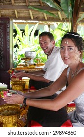 Western Couple Getting Married During A Traditional Buddhist Wedding In Thailand.