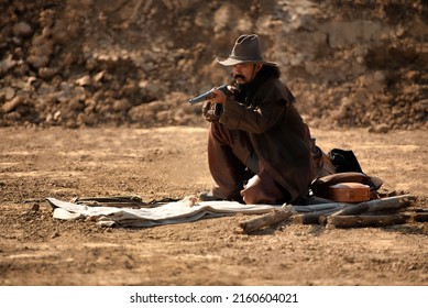 western cowboy portrait Holding a gun in a dry area