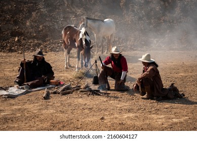 western cowboy portrait Holding a gun in a dry area, while cooking.