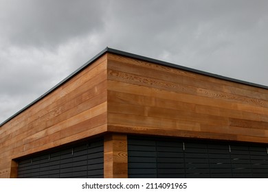 Western red cedar cladding, wood facade, geometric architecture detail against dark sky