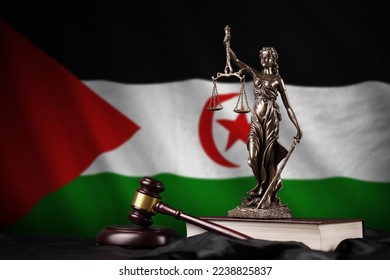 Western Sahara flag with statue of lady justice, constitution and judge hammer on black drapery. Concept of judgement and punishment
